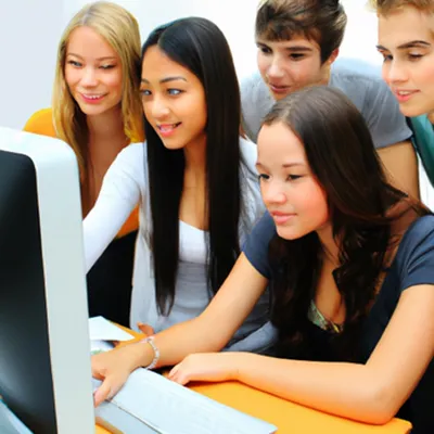 Five young students looking at a monitor - image by DALLE2